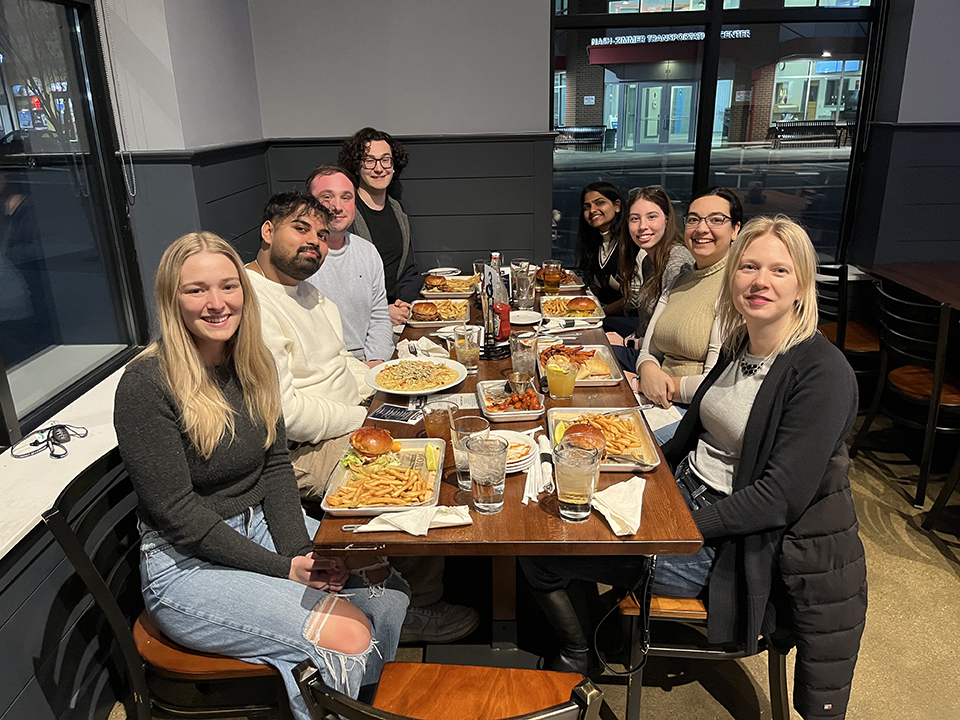 Erceg Lab sitting at a long table in a restaurant