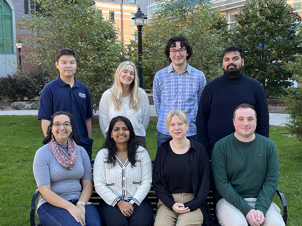 Ercec Lab members sitting on a bench