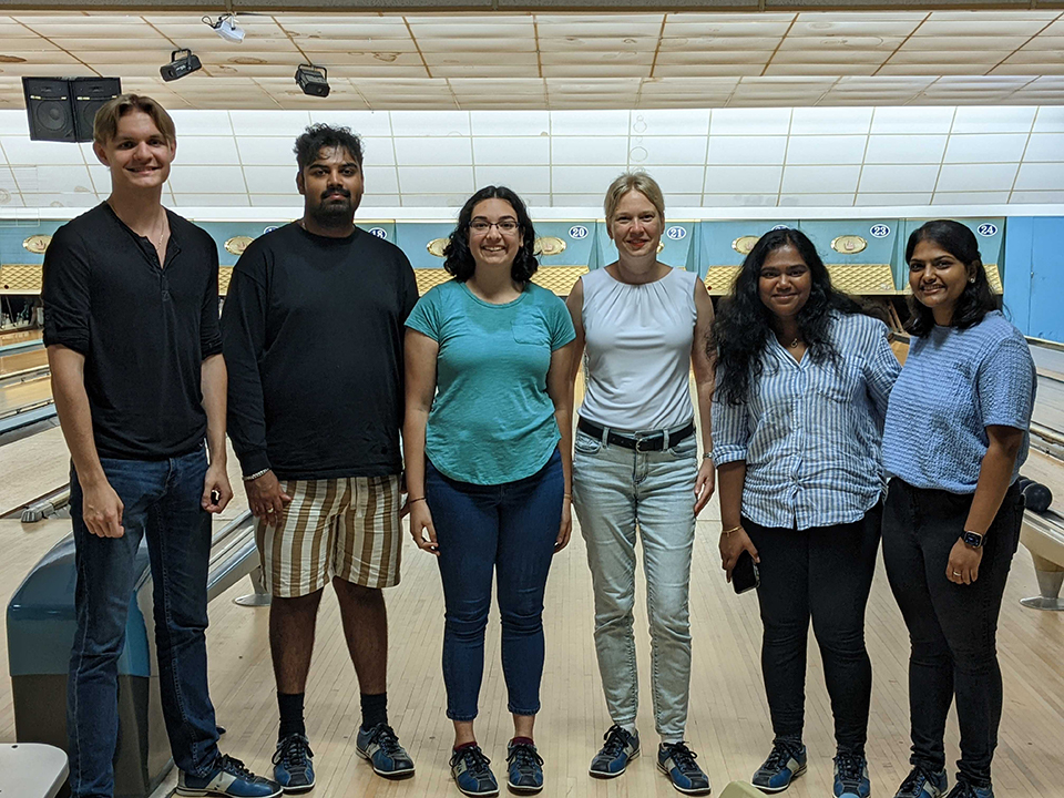 Lab members standing in a bowling alley